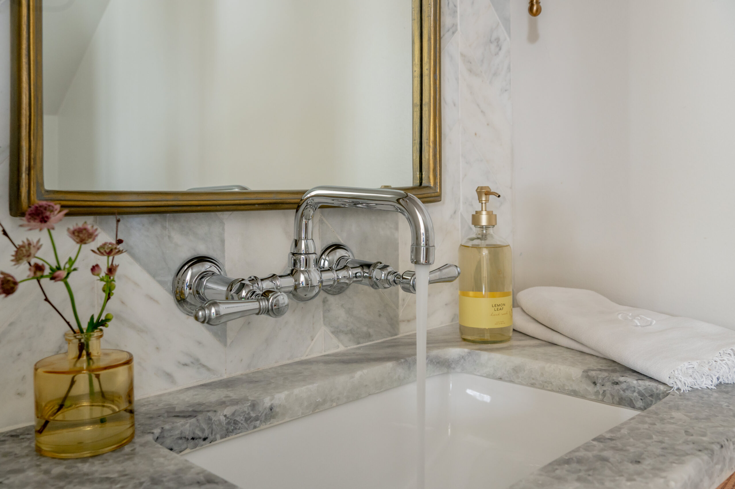 Marble bathroom sink with faucet running water