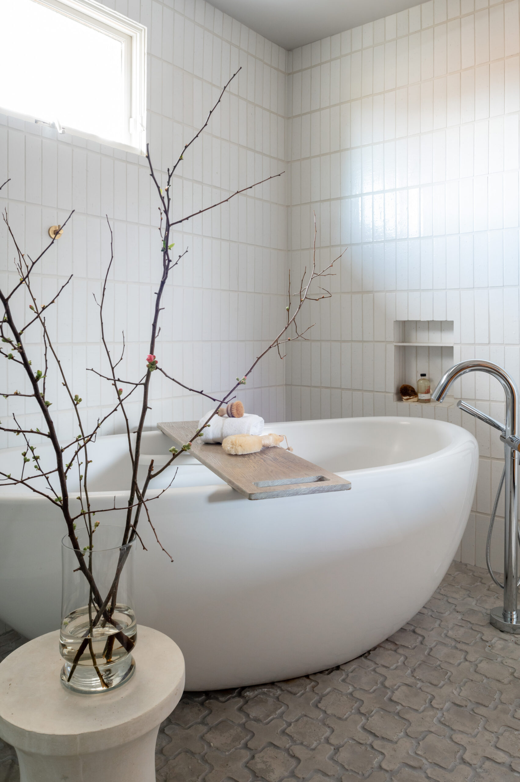 Stunning white bathtub in a luxury tiled bathroom