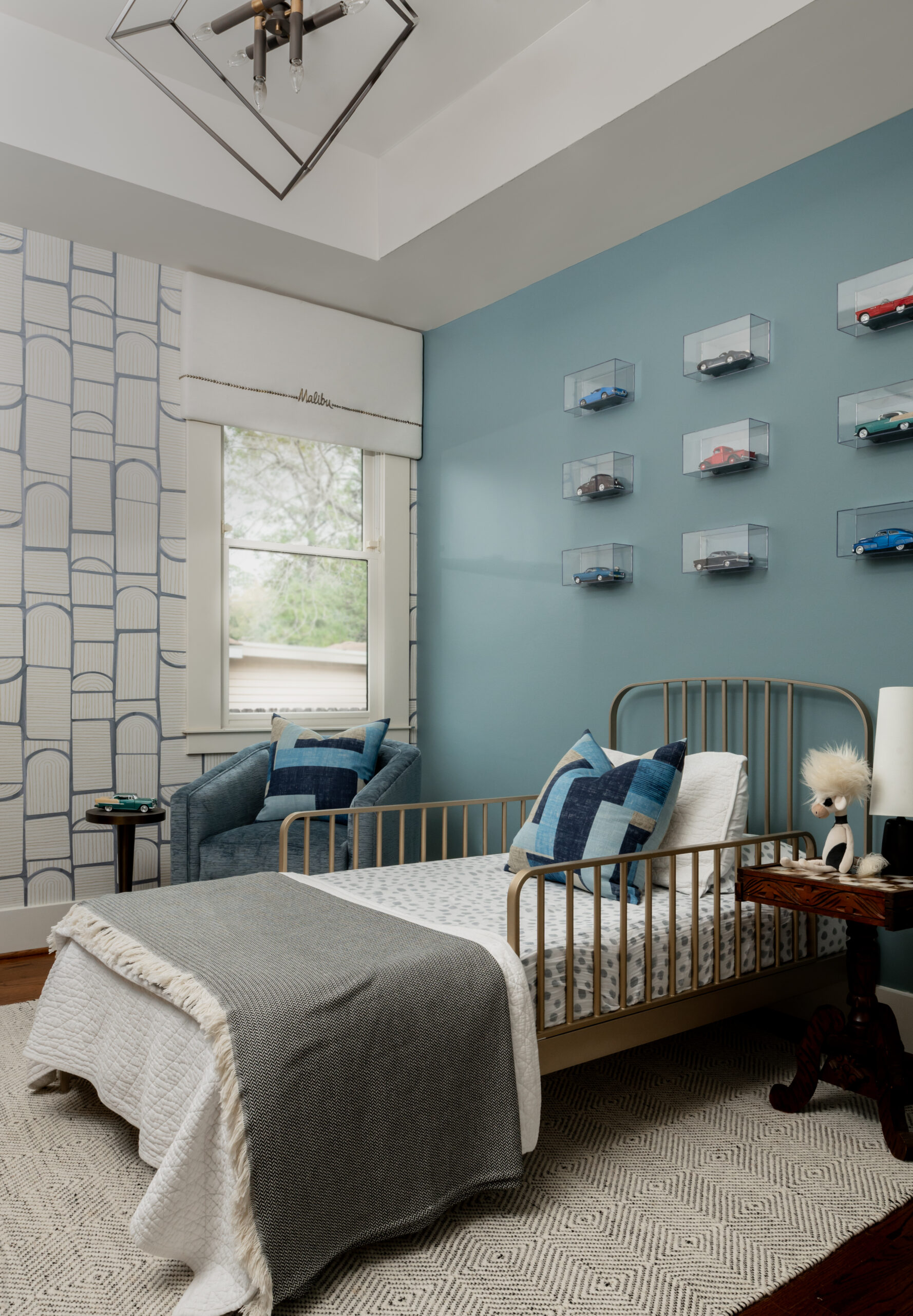 Boys bedroom interior design with car wall art and bed