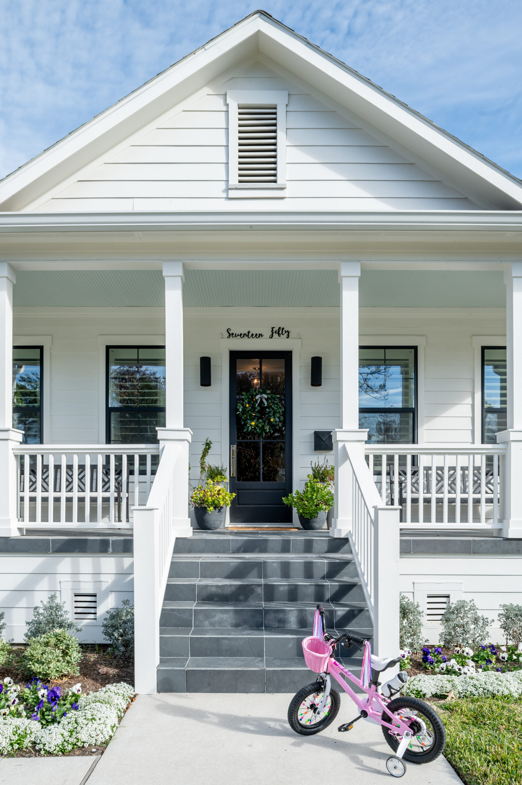 Exterior design of a white home with gray stone steps