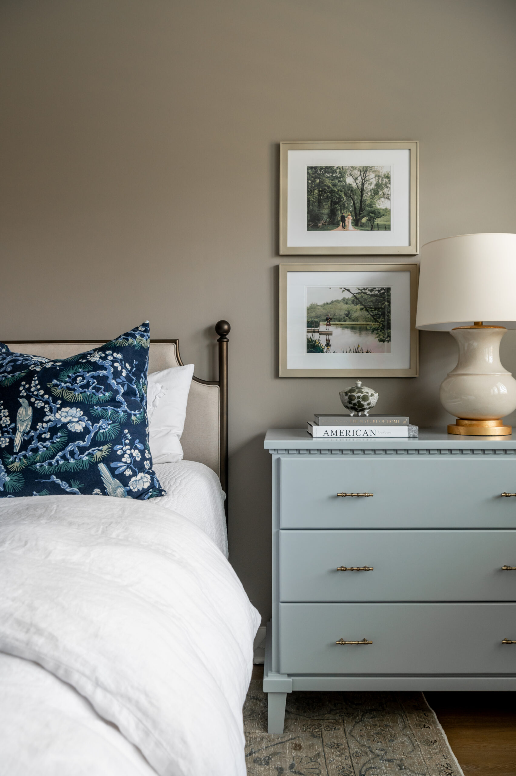 Modern bedroom interior design with blue dresser and wall art