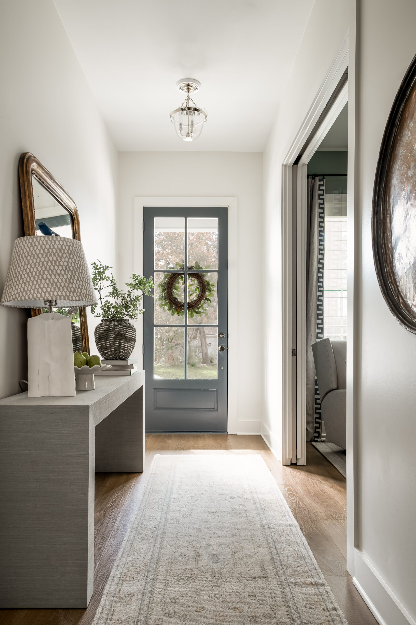 Bright home entry way with natural light shining through front door