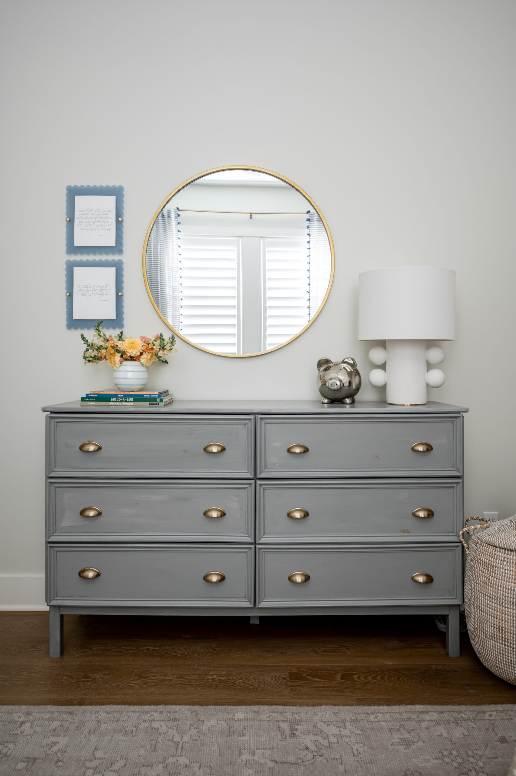 Bedroom with grey dresser and wedding vows hanging on the wall