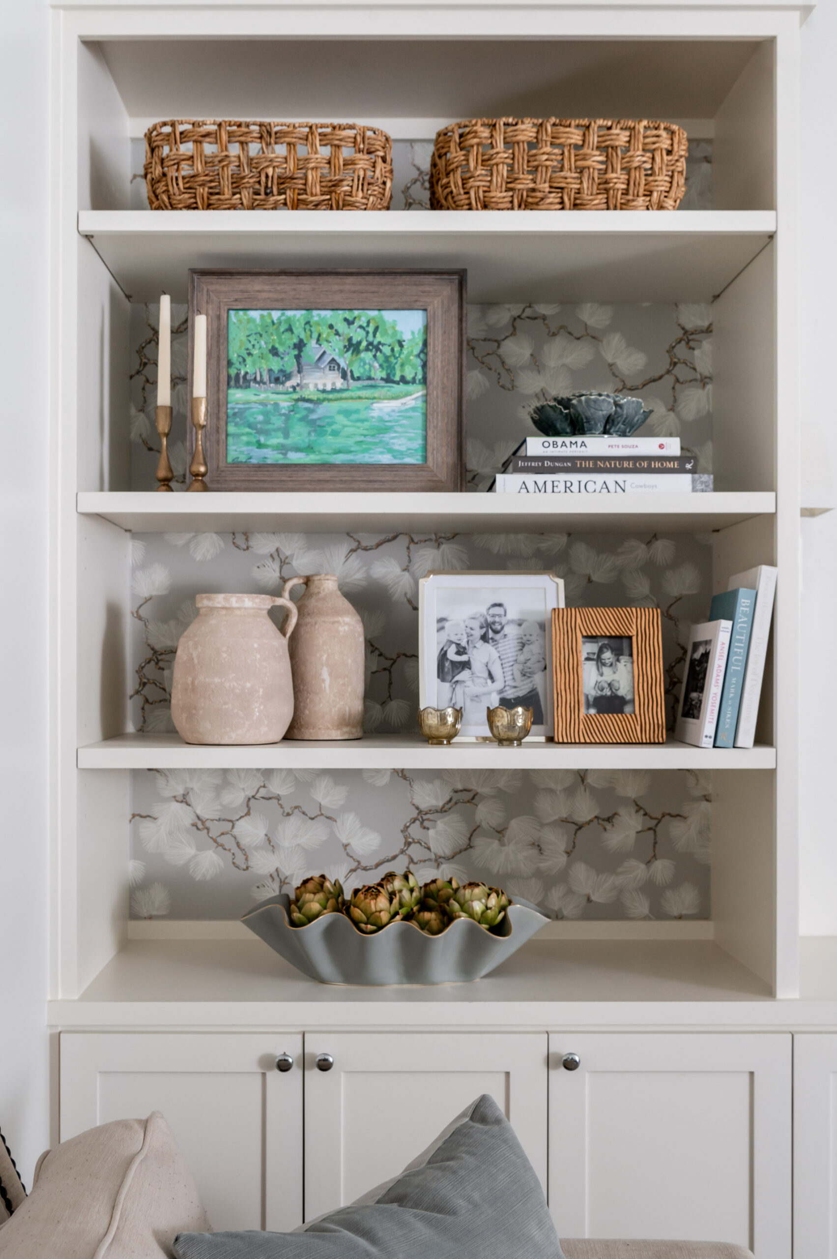 Living room shelving styled with books and decor