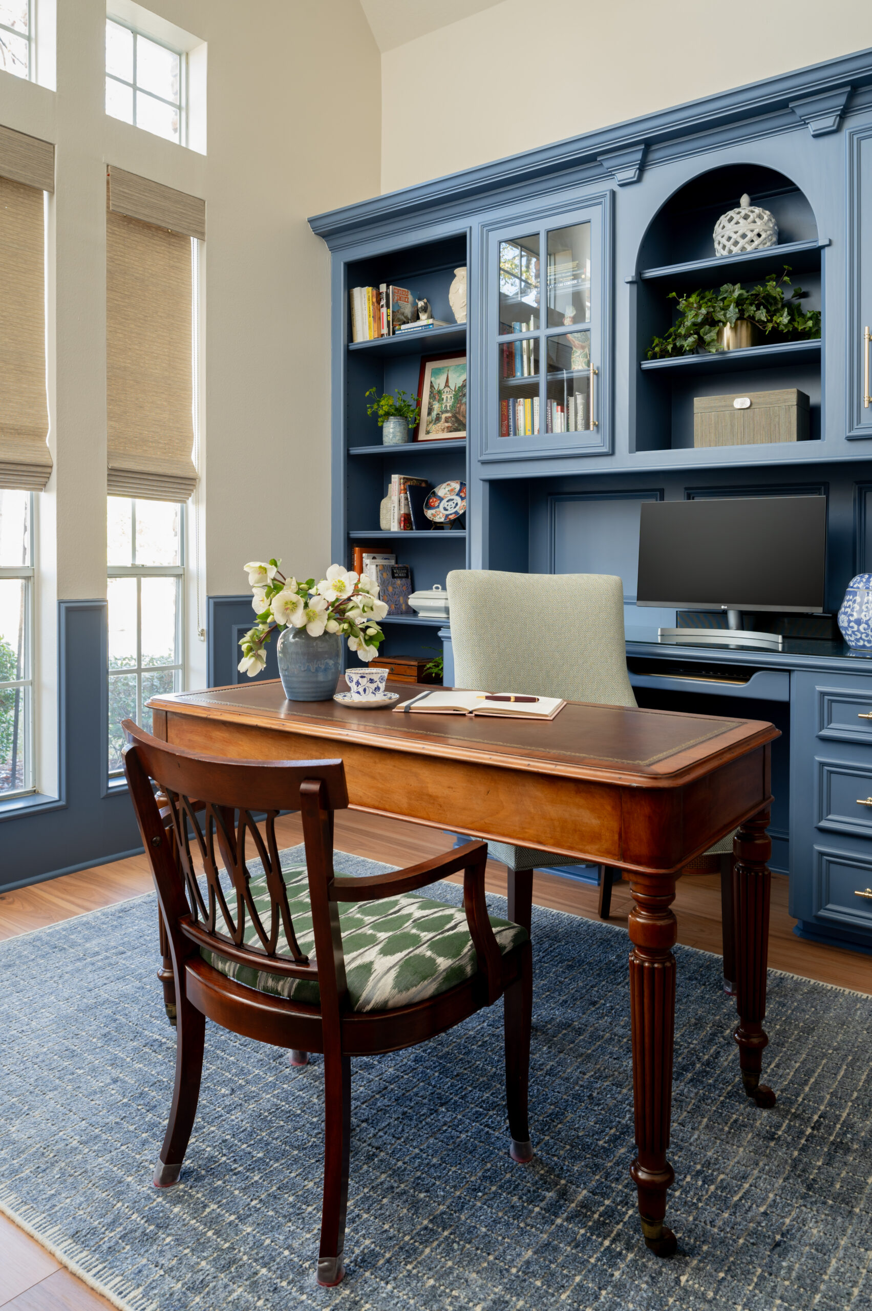 Beautiful office interior design with blue book case and wooden desk and chair