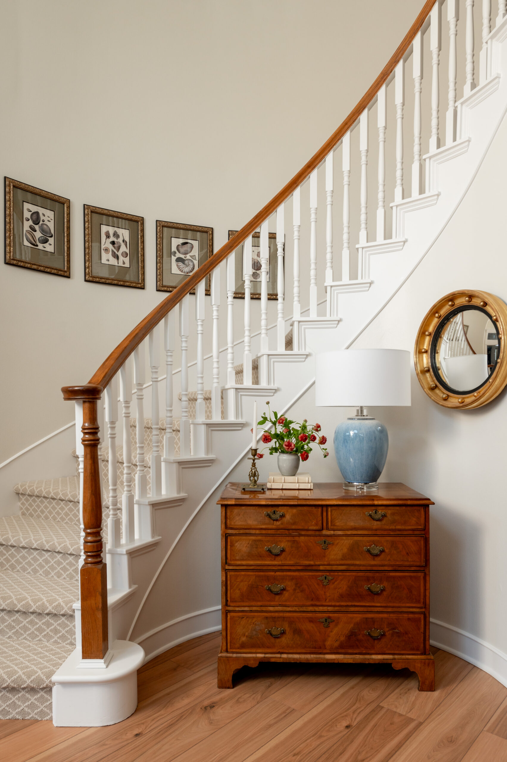 Stunning entryway with wooden dresser and spiral stairs