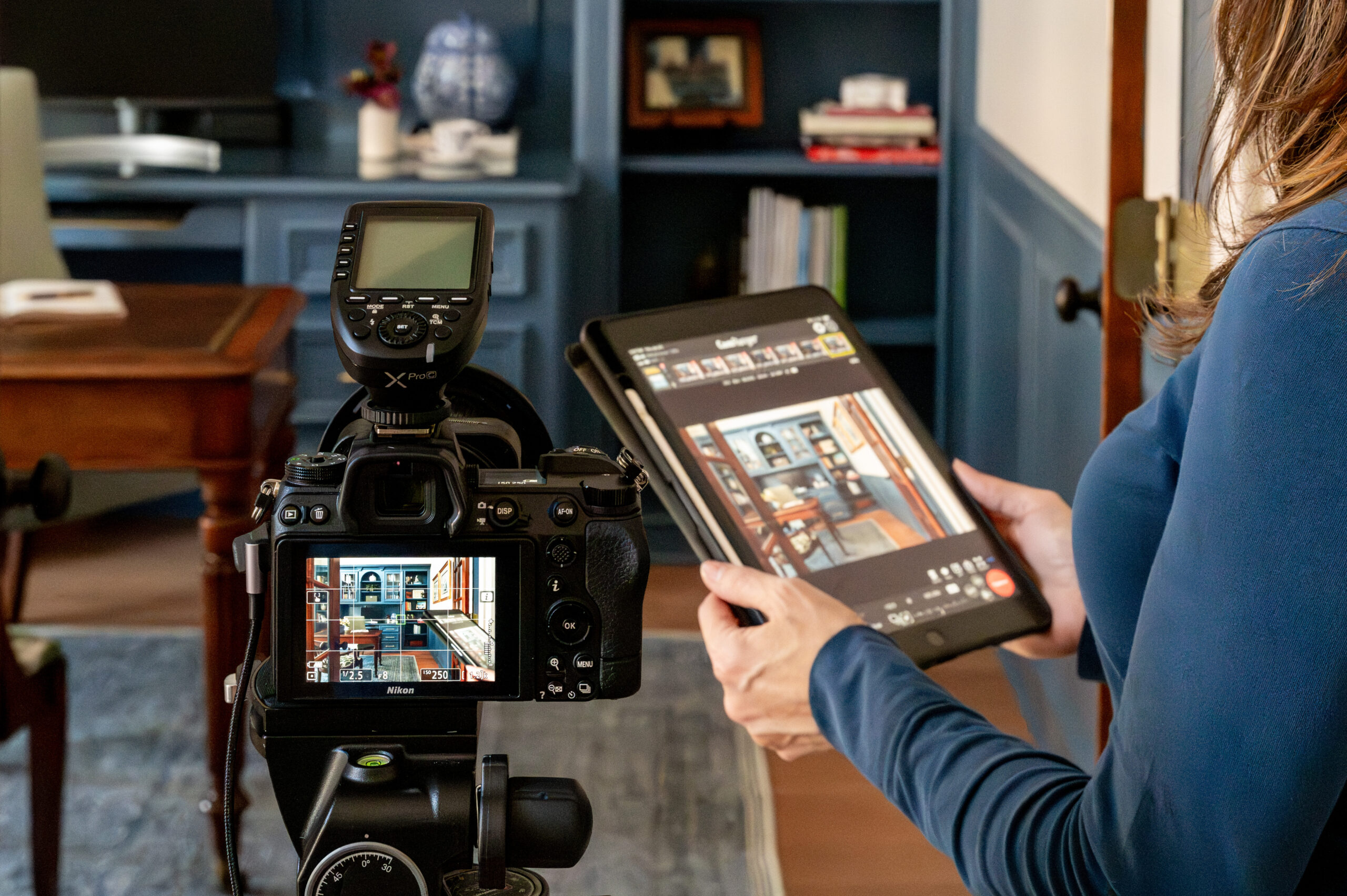 Woman holding iPad connected to a camera for a tethered photography session