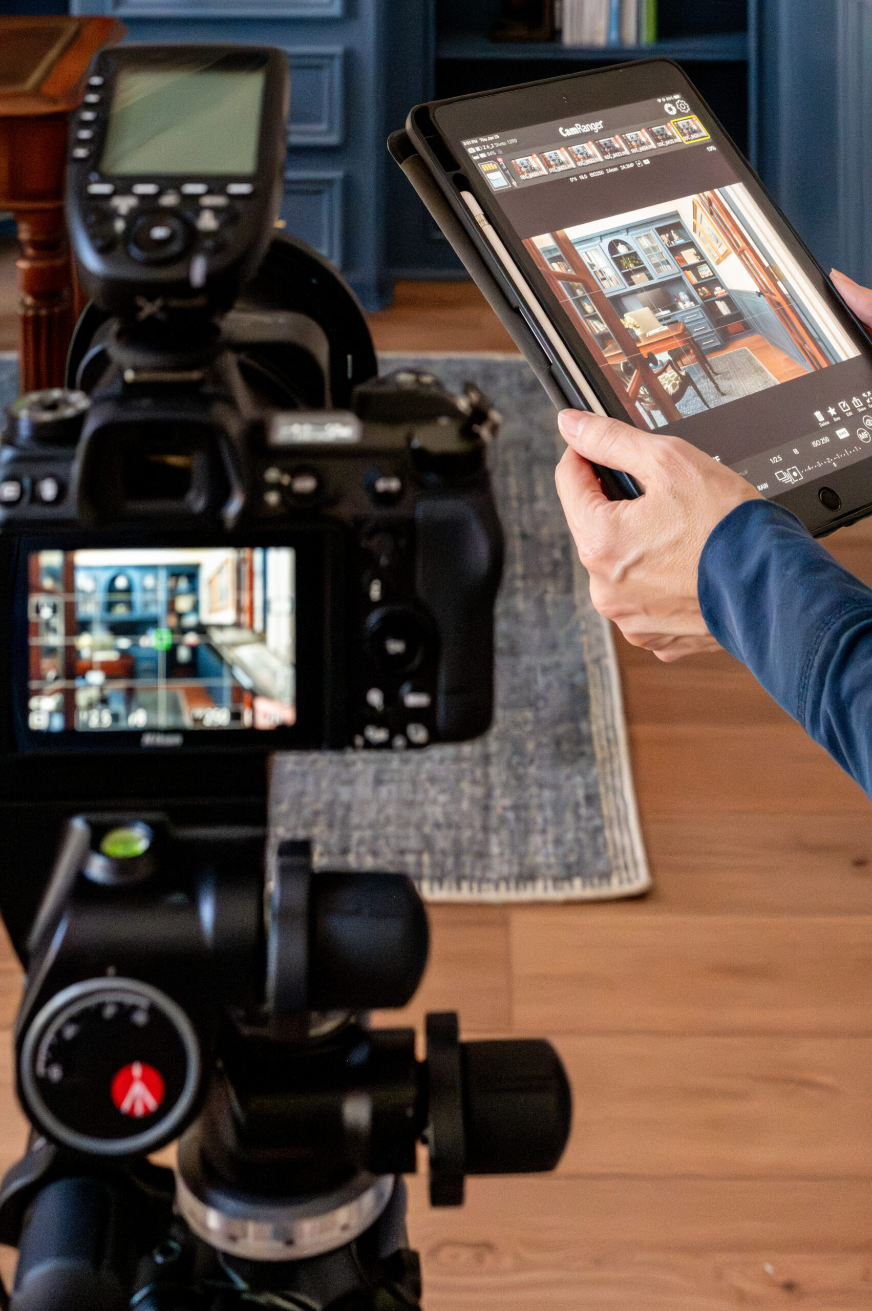 Woman holding iPad connected to a camera for a tethered photography session