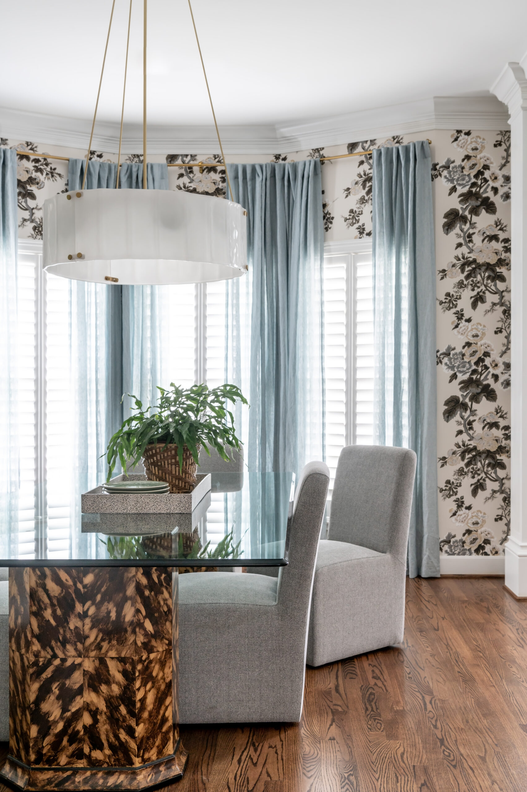 Dining room interior design photo of dream wallpaper, paired with custom-painted table bases in a tortoiseshell pattern
