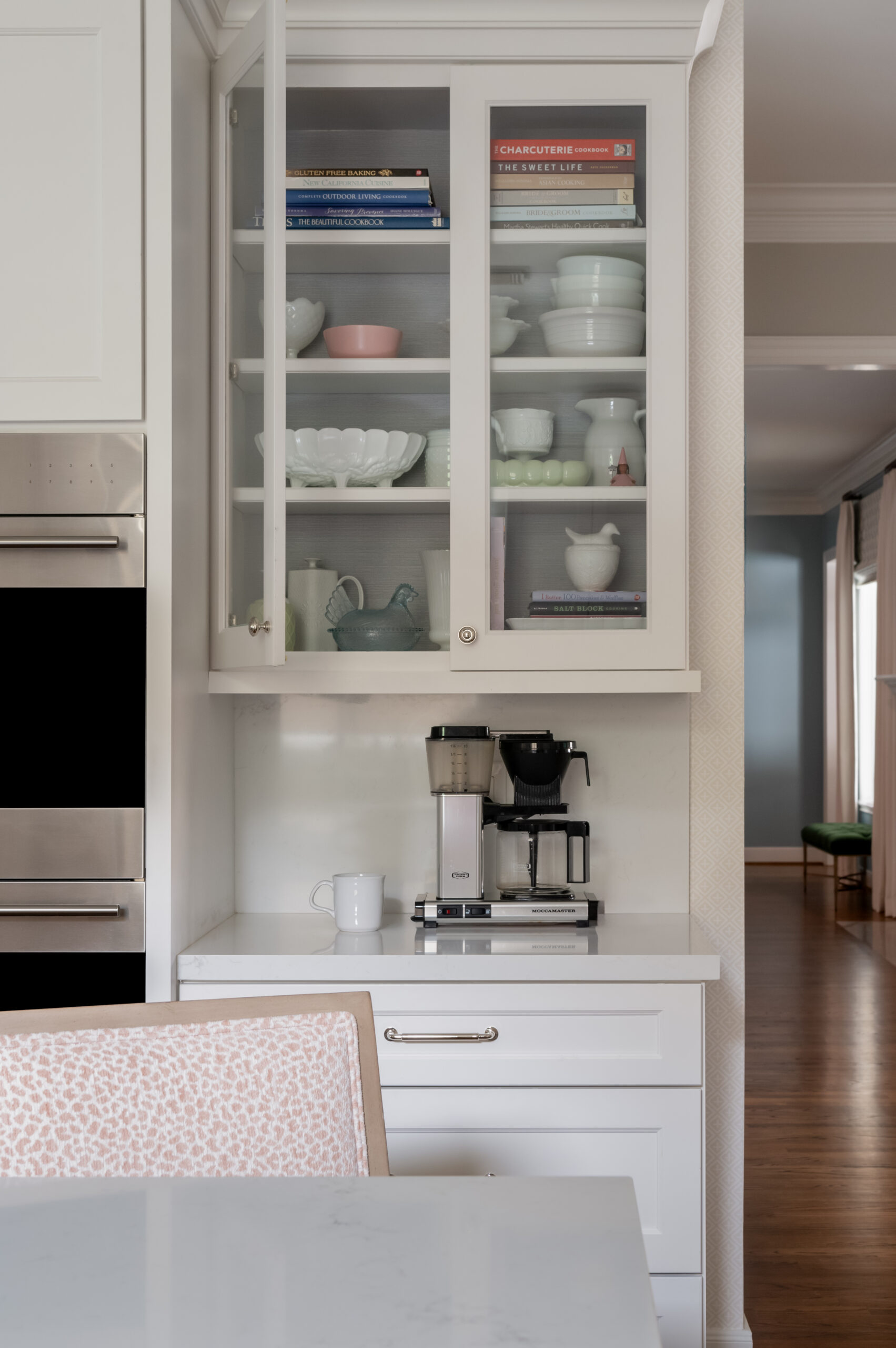 Kitchen interior design photo of kitchen cabinets styled with dishes and coffee maker