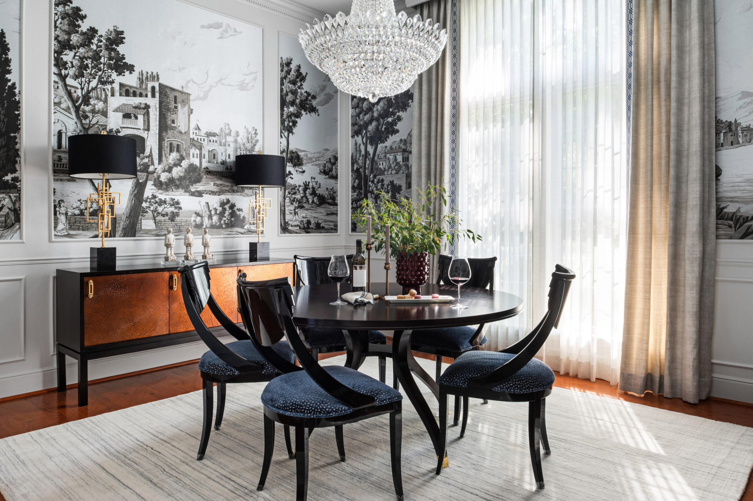 Bold dining room interior design with mural wall and crystal chandelier