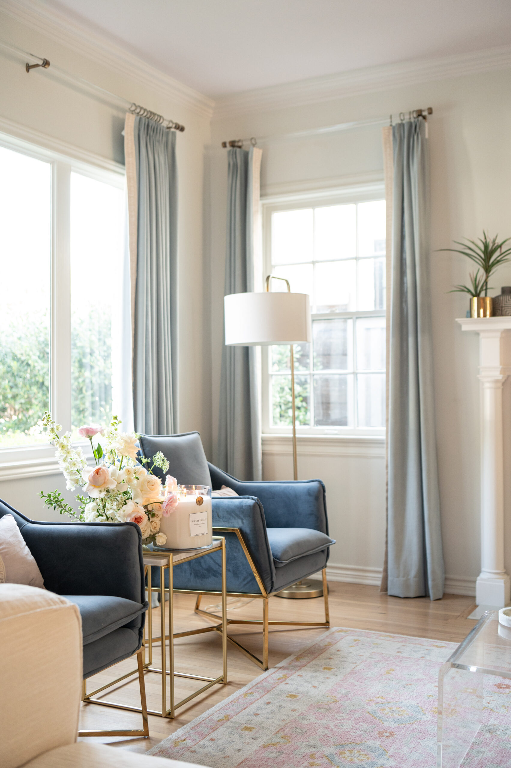 close-up of beautiful floral arrangements with a candle, elegantly arranged in a living room corner, highlighting the soft glow and serenity in seasonal photography.