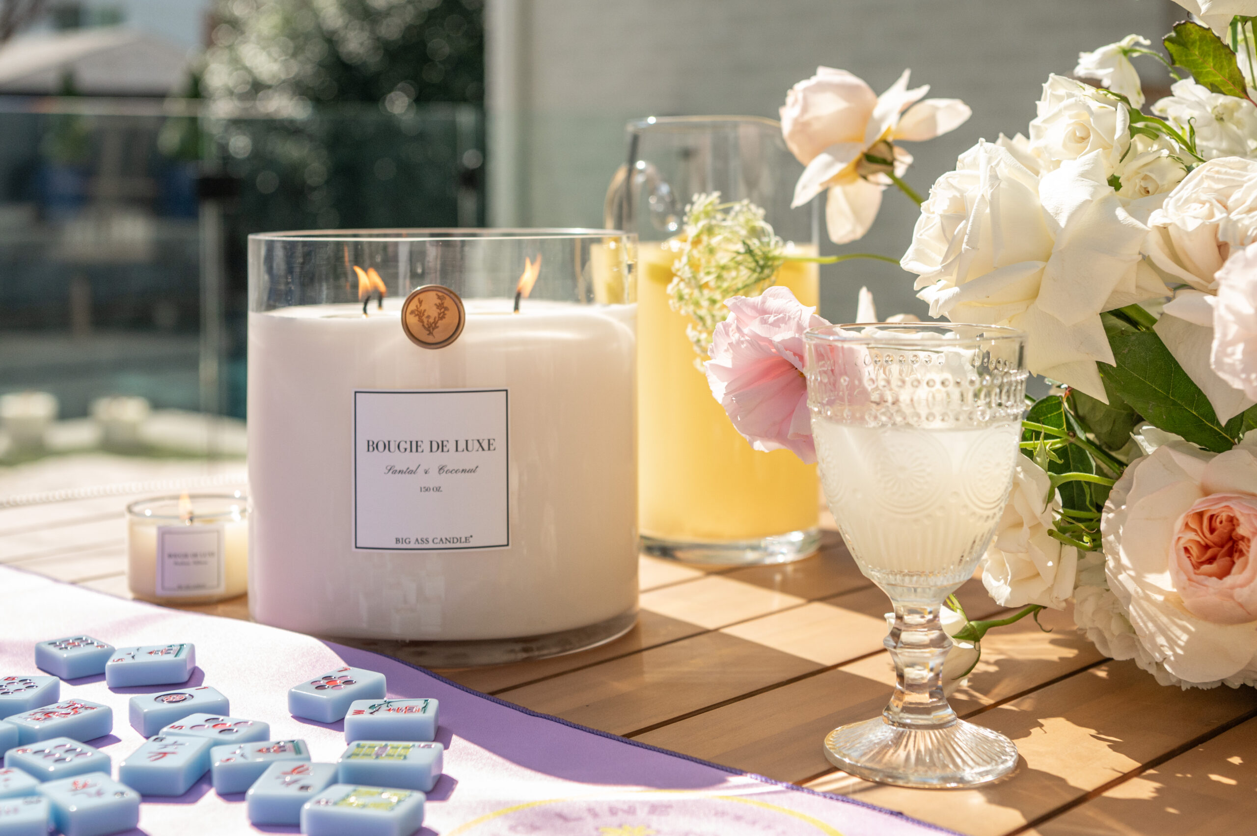 a beautiful floral arrangement and a candle burning, captured in a moment of seasonal photography for a spring branding shoot.