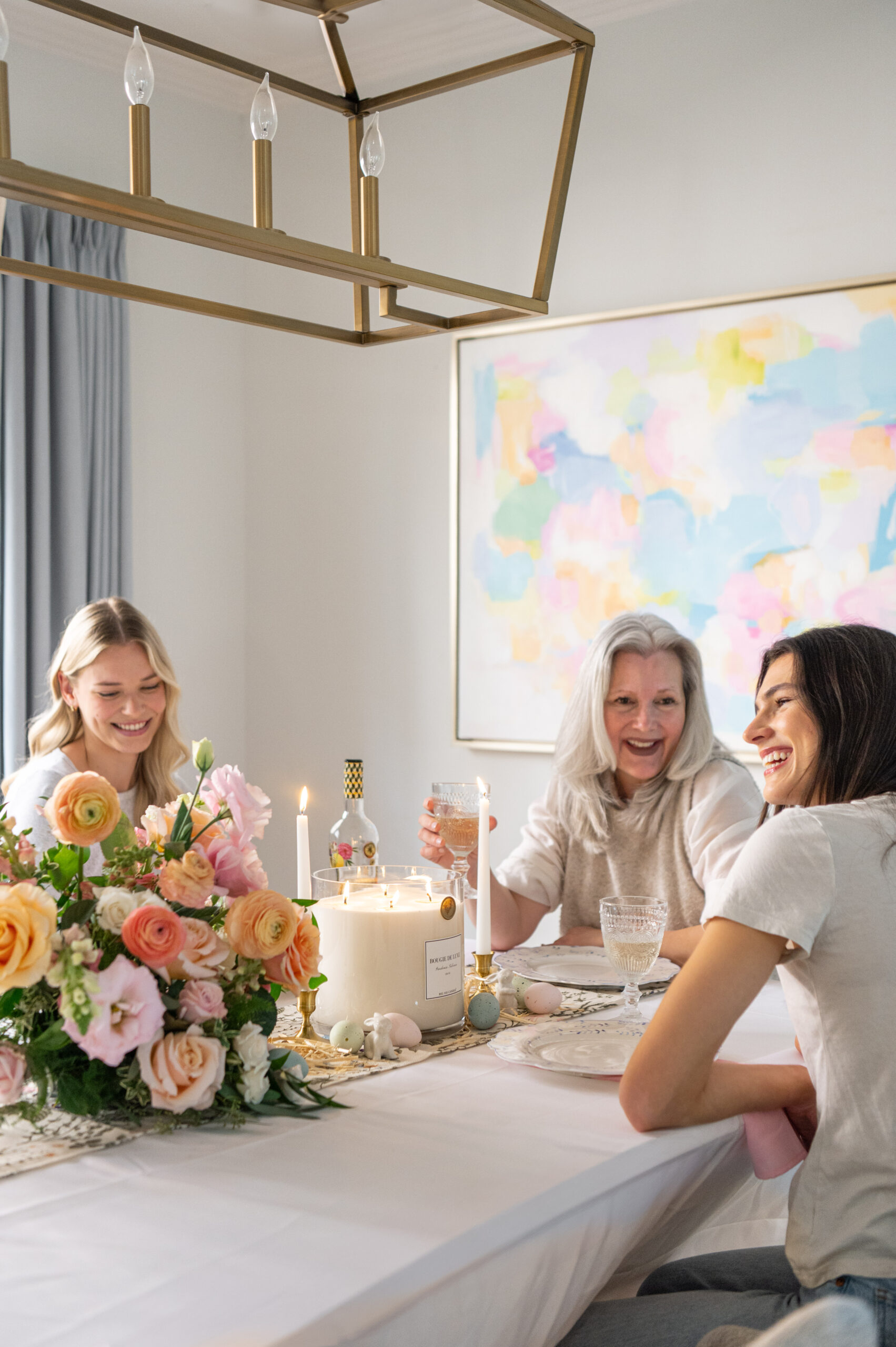 A joyful family enjoying a cozy table setting with candles, flowers, and seasonal decor, perfect for seasonal photography showcasing warmth and connection.