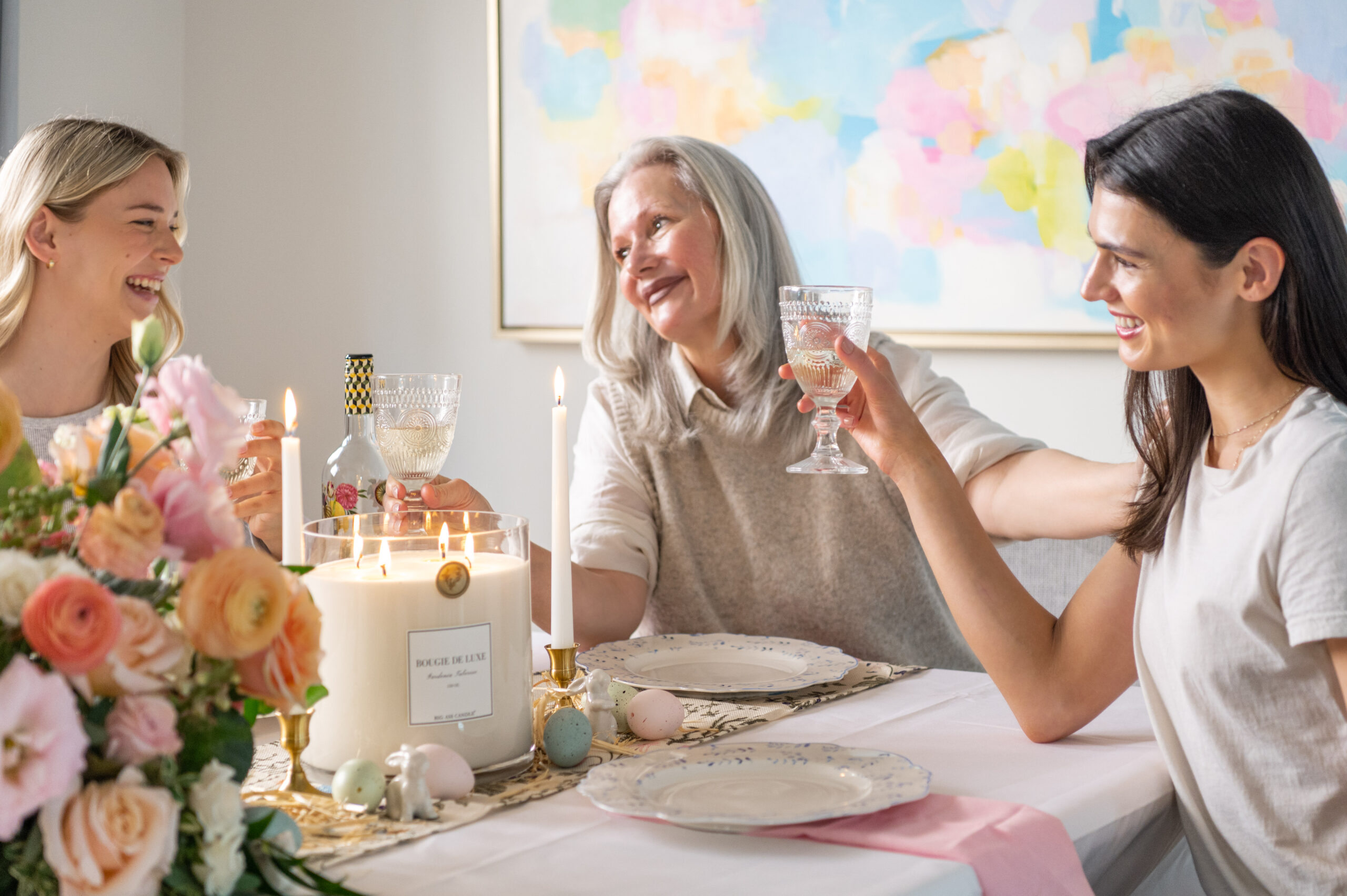 A joyful family enjoying a cozy table setting with candles, flowers, and seasonal decor, perfect for seasonal photography showcasing warmth and connection.