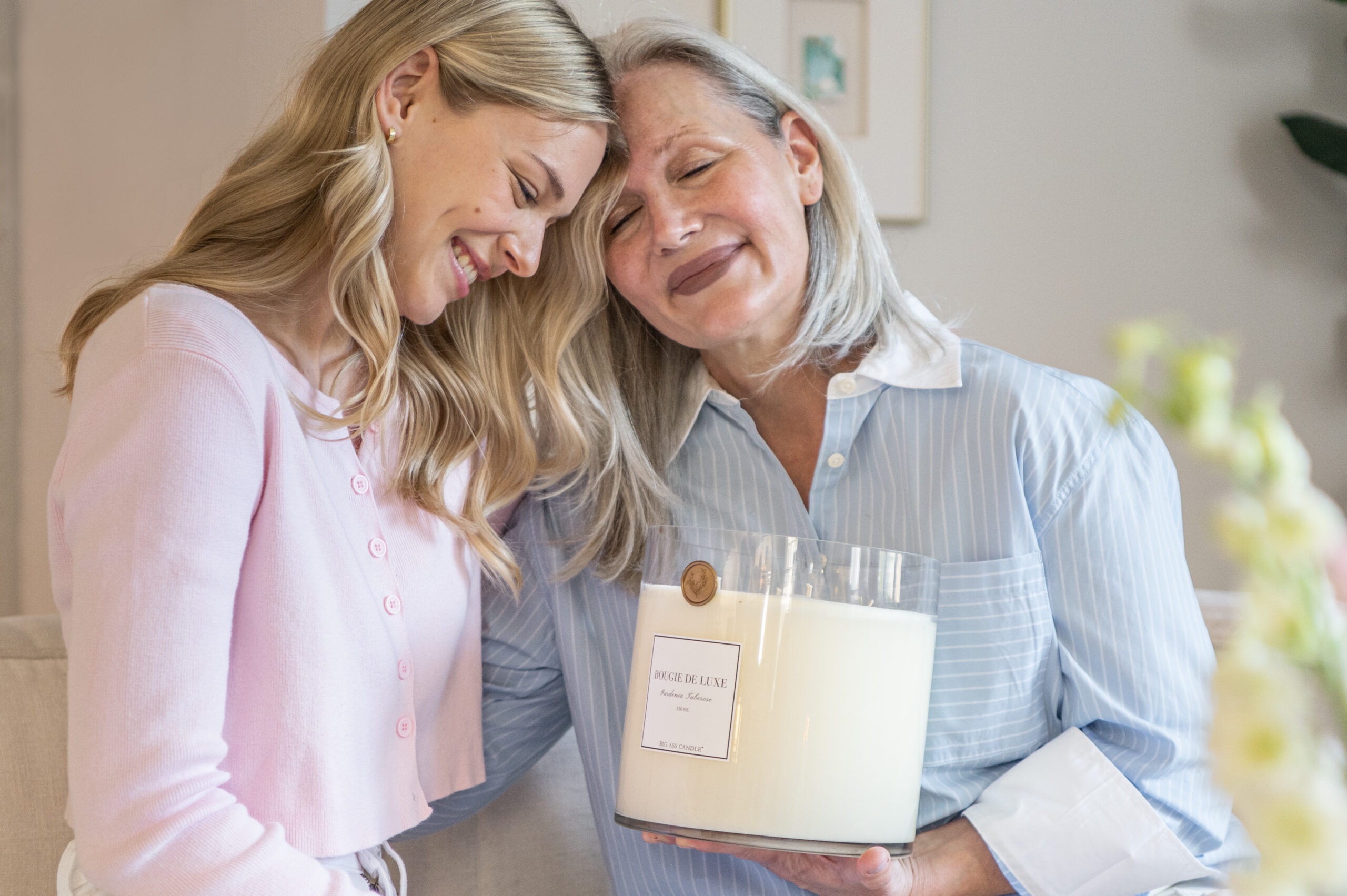 A heartfelt moment between a mother and daughter exchanging a gift, a perfect capture for seasonal photography celebrating family love and gifting traditions.