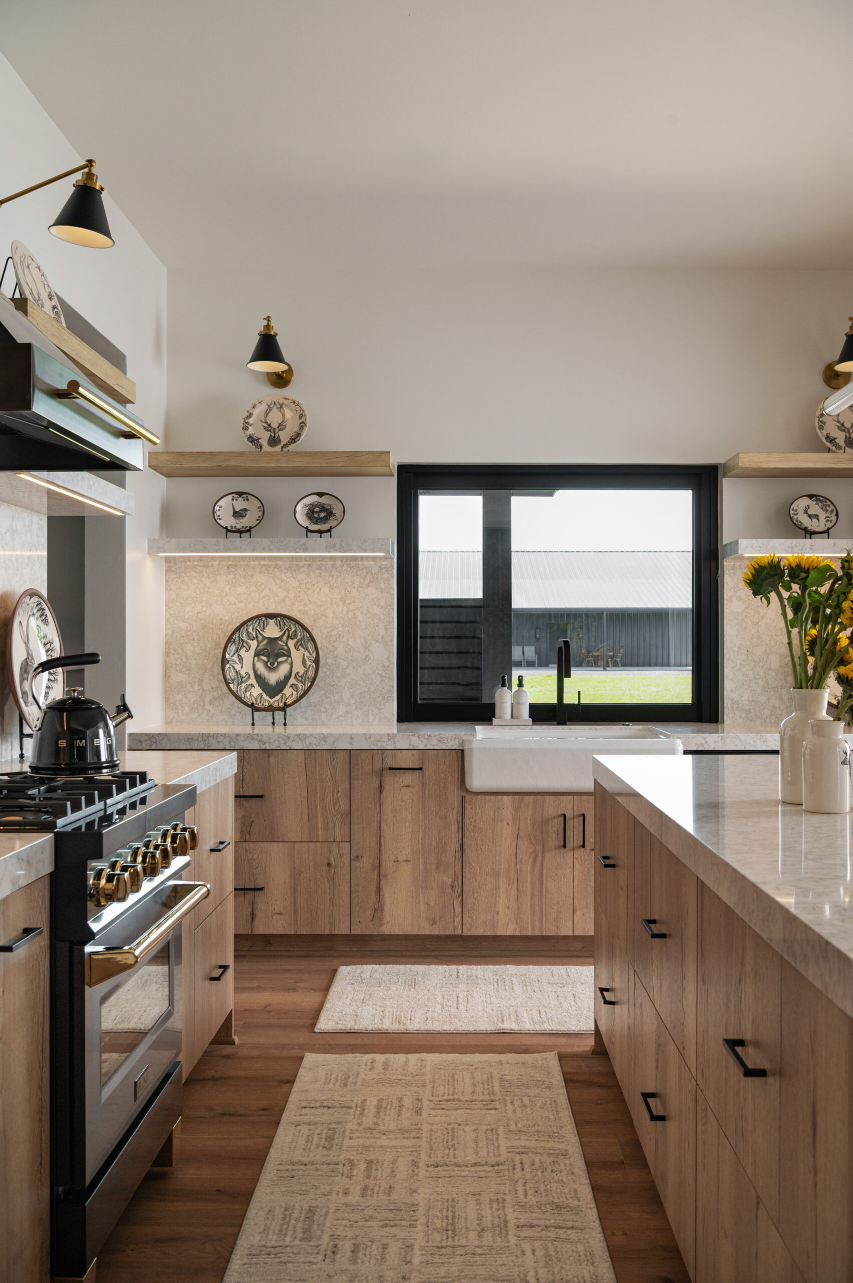 Visual storytelling photography capturing a farmhouse-modern kitchen with natural wood cabinets, dramatic black fixtures, and whimsical plate decor styled with symmetry and intention.