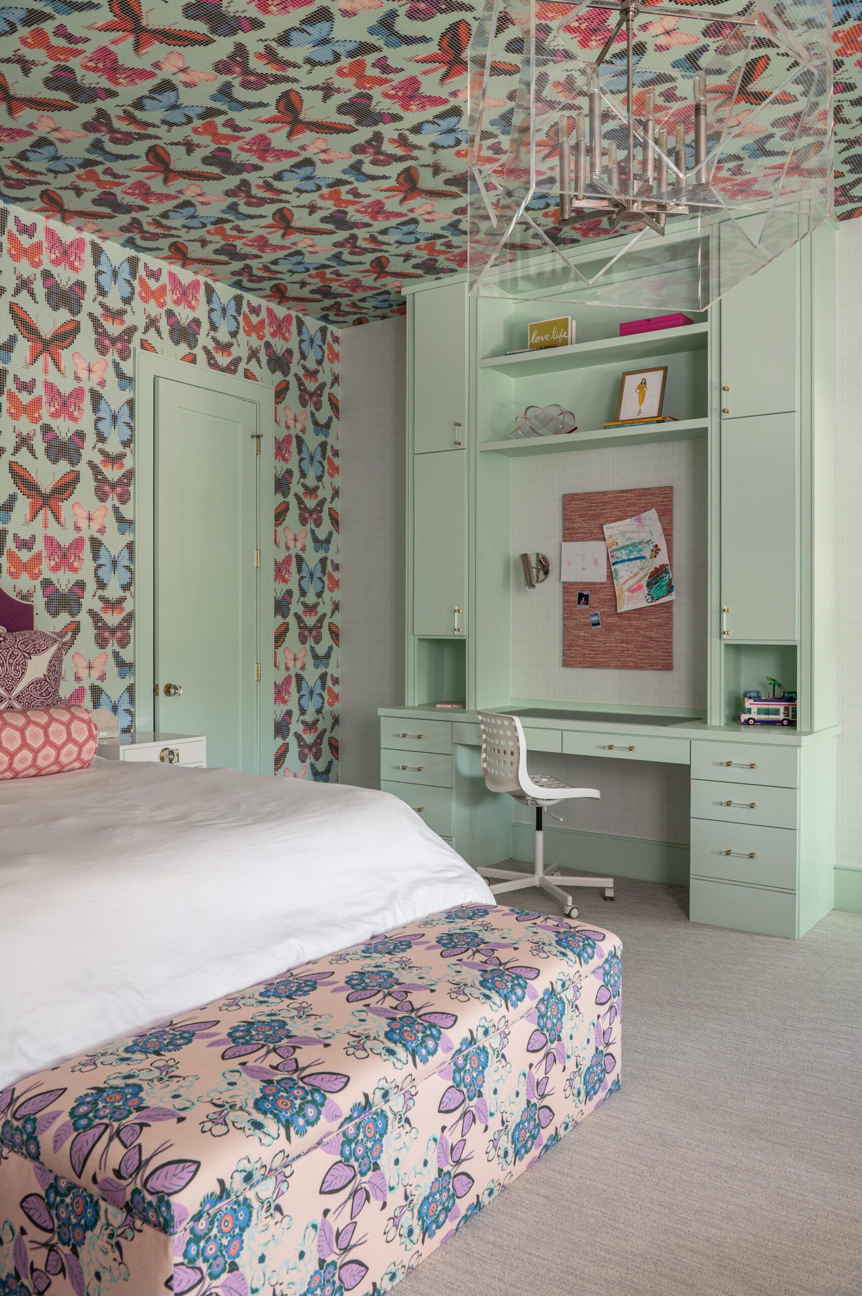 Tween Bedroom Interior Design showcasing butterfly wallpaper, mint cabinetry, and a floral bench at the foot of the bed.