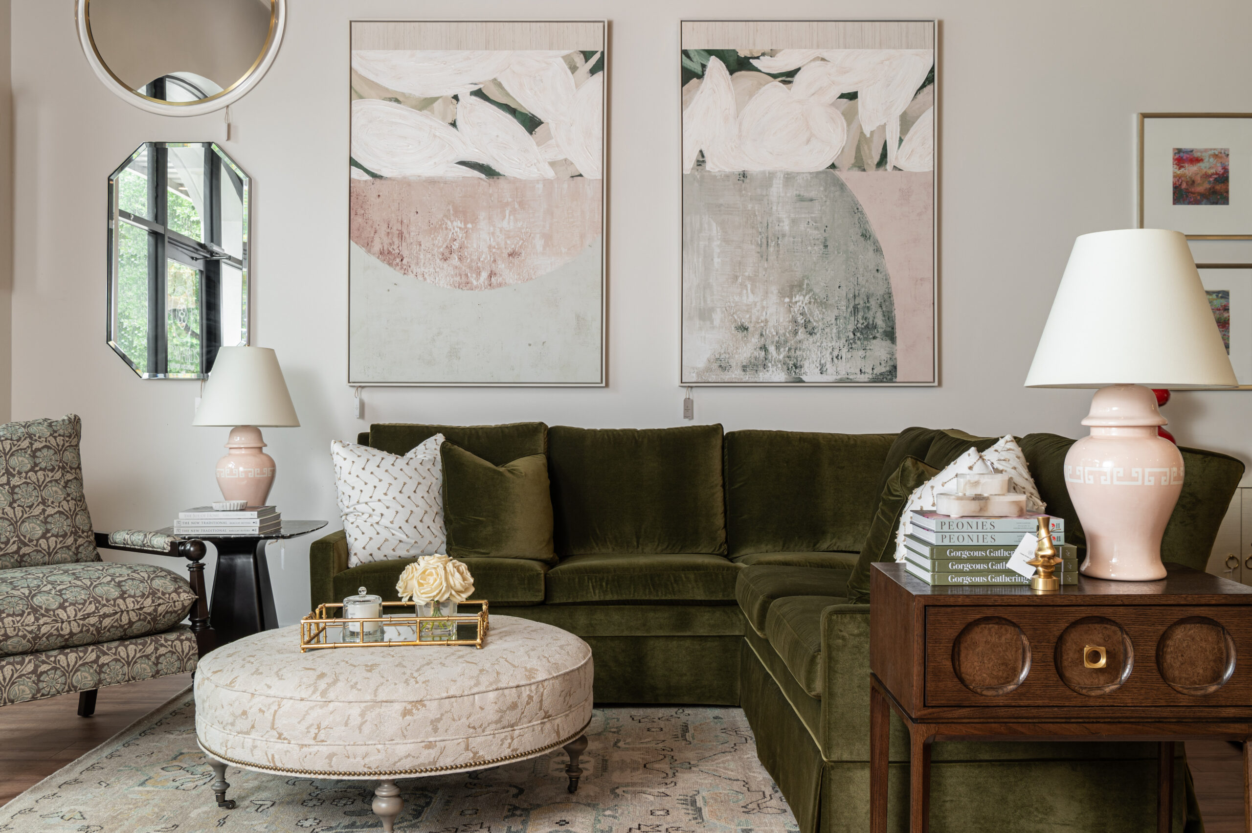 Warm and inviting living room featuring a green velvet sectional, abstract artwork, and pink ceramic lamps—perfectly styled for brand photography that highlights high-end interior design.
