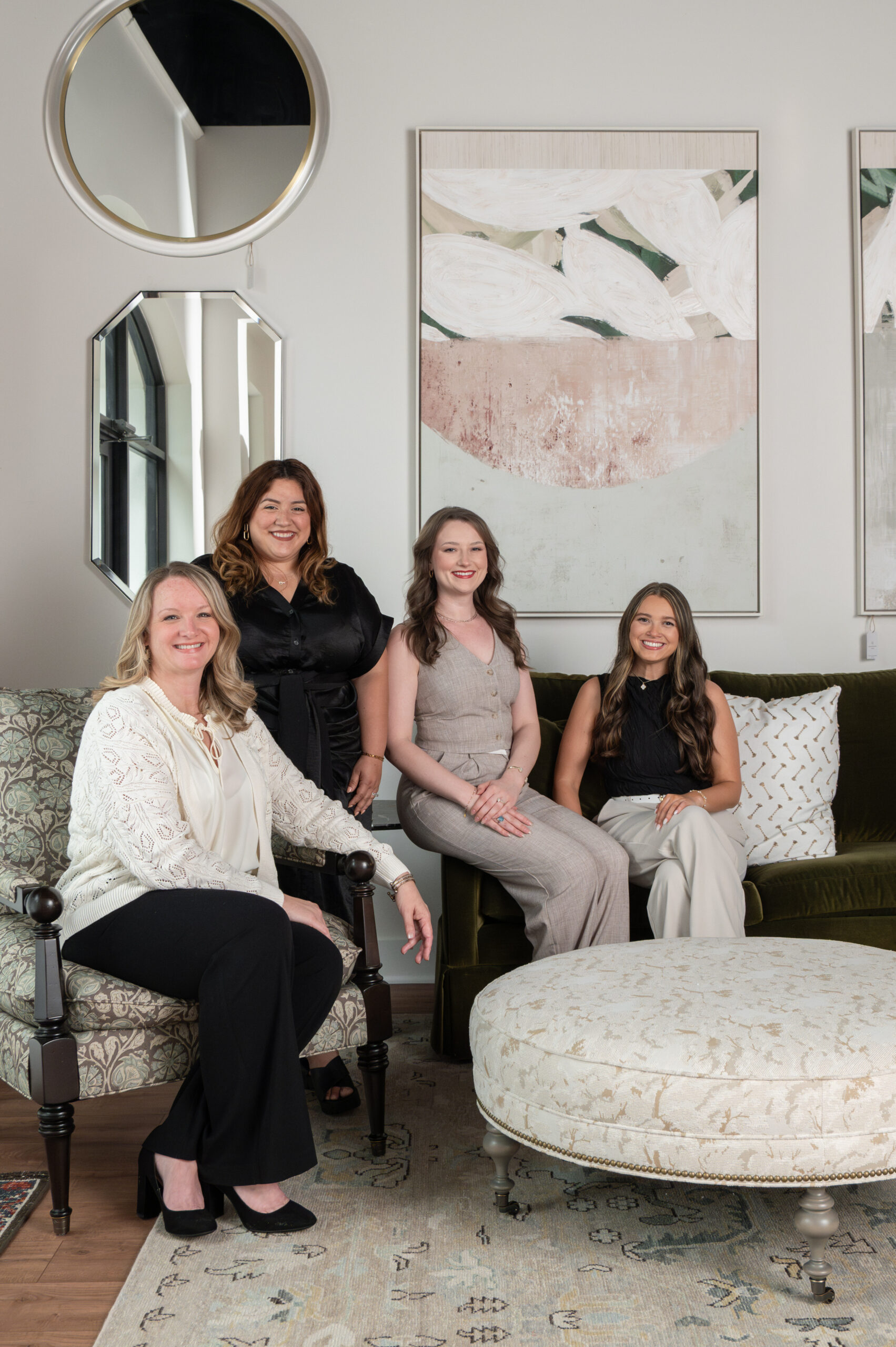 Team portrait of four women in a curated lounge space, captured by an Austin brand photographer for a stylish and welcoming brand image.