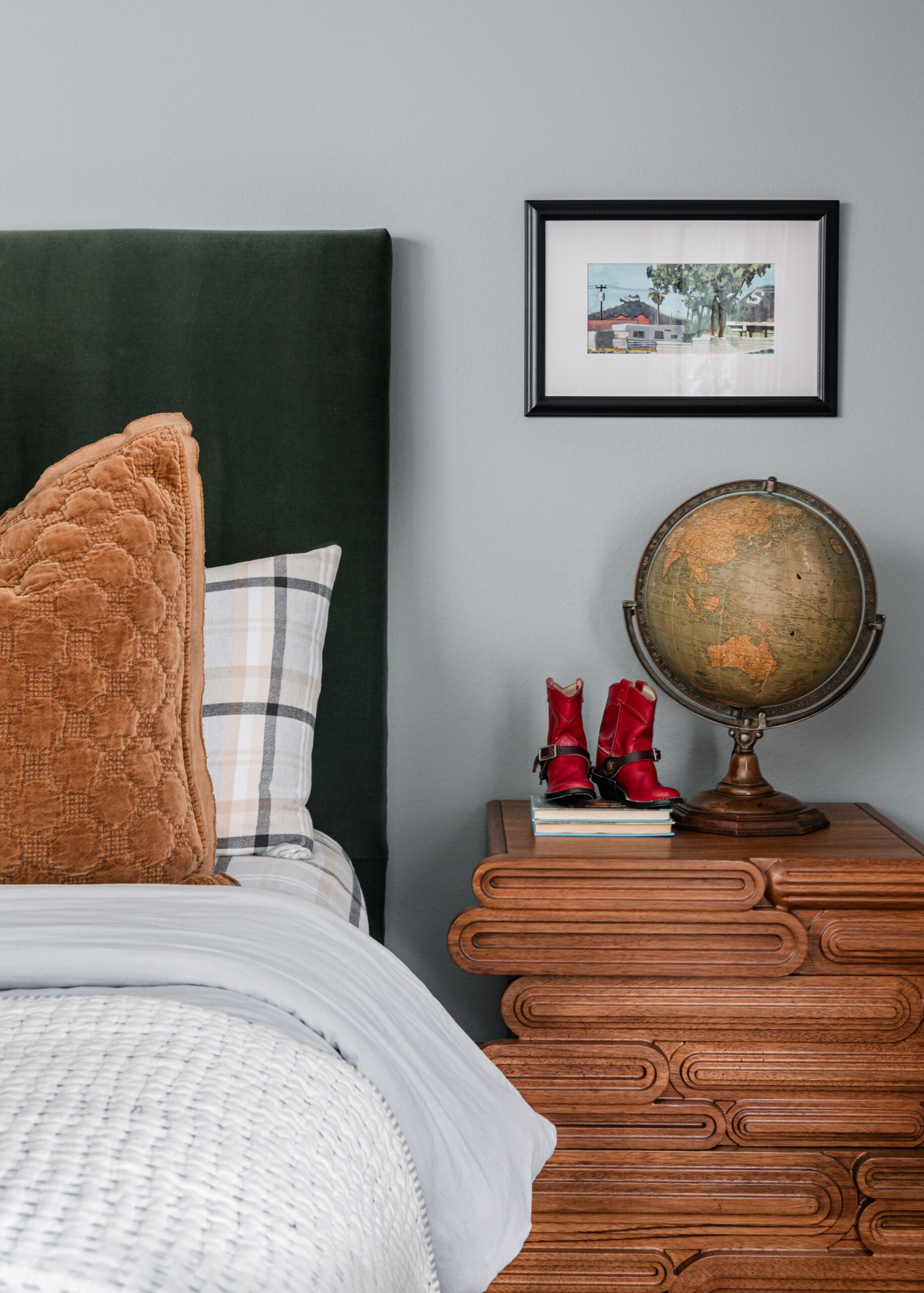 Warm and layered bedroom featuring plaid carpet, a mix of cozy textures, and a chocolate lab—a thoughtful blend of comfort and design.