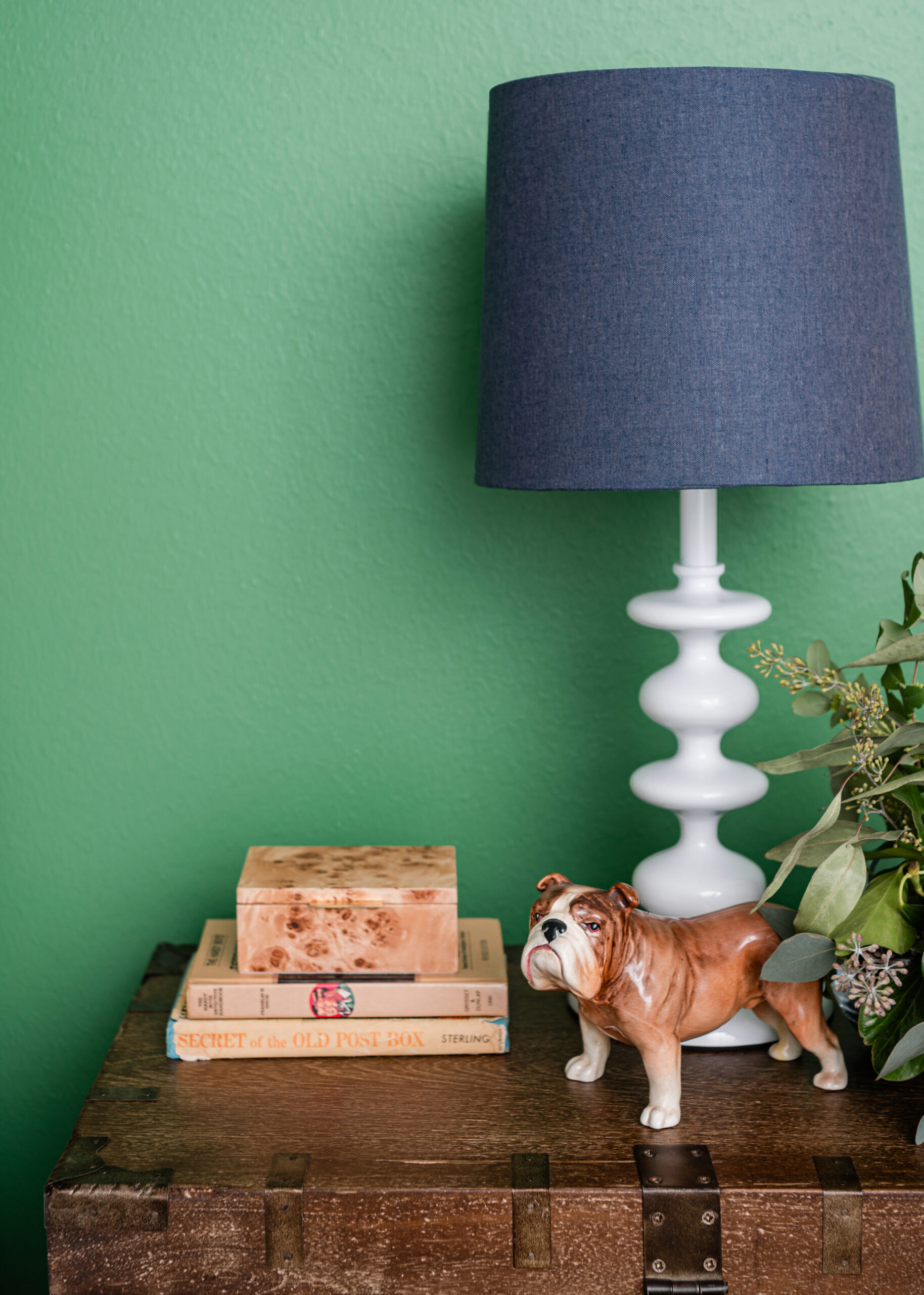 Whimsical bedside styling with a ceramic bulldog, classic books, and a modern white lamp—perfect for adding character to a kid’s room.