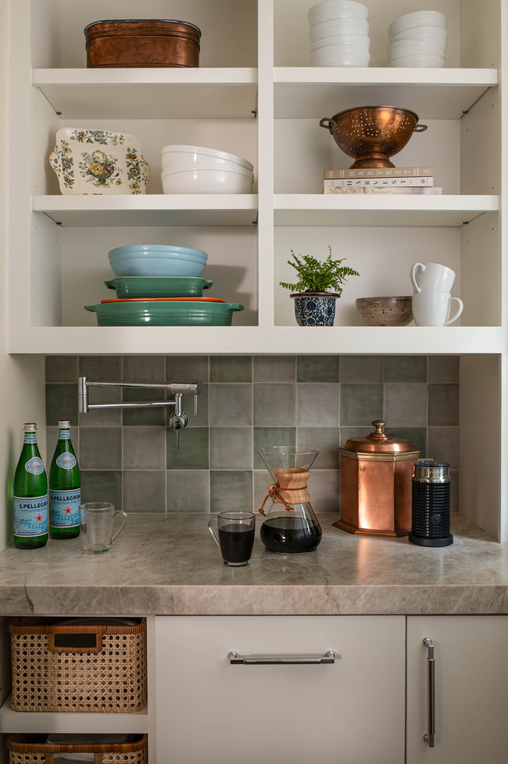 Vignette photography of a coffee nook with open shelves, green tile backsplash, and vintage copper canisters.