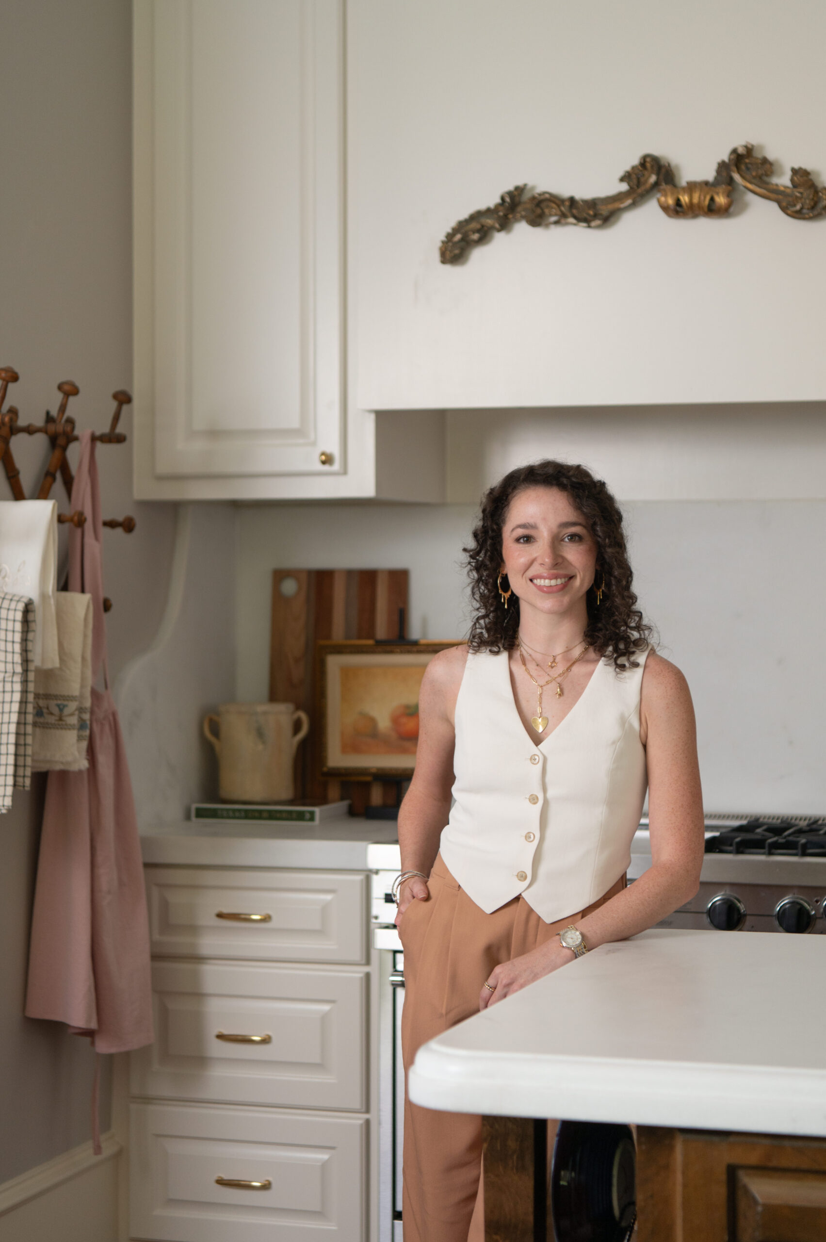 Melissa, the interior designer behind Carte Blanche, standing in her client’s newly redesigned kitchen, smiling confidently in front of custom cabinetry and styling accents.