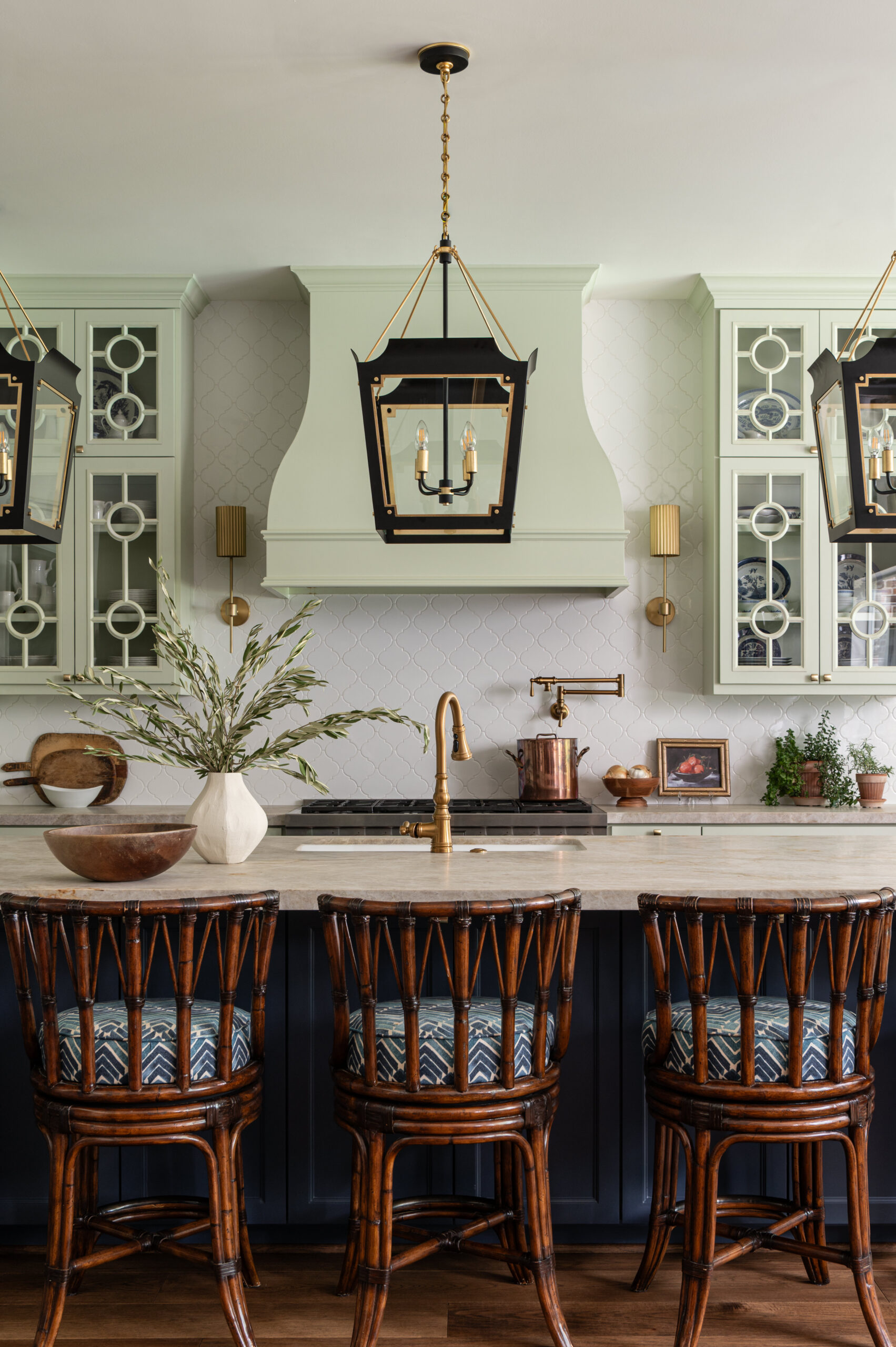 Moody yet bright kitchen with color pops of blue and green with fantastic bamboo bar stools